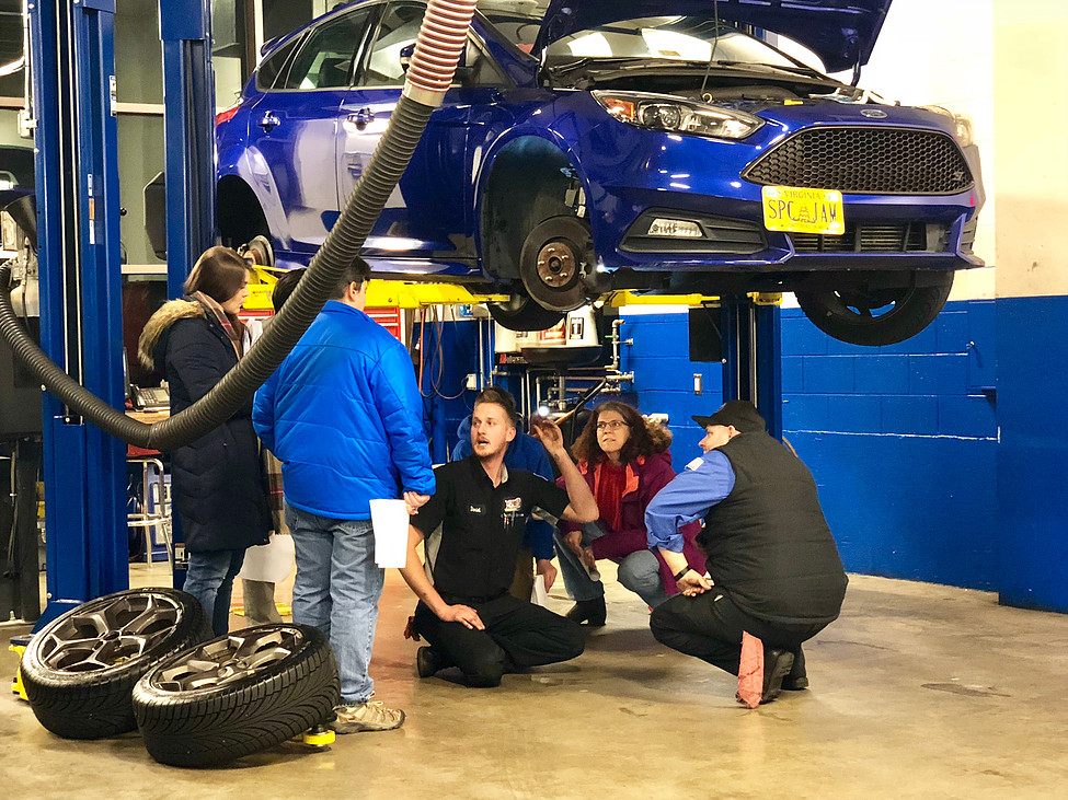 Yates technicians inspecting a vehicle on the lift